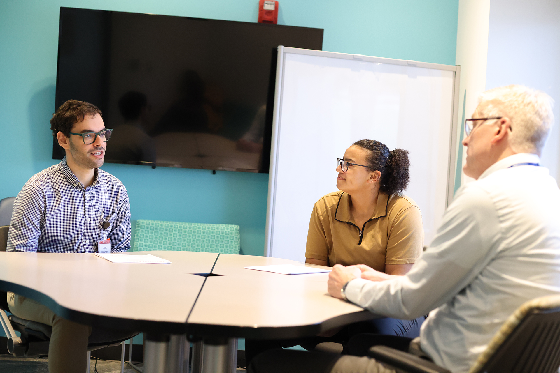 Nick Holekamp, MD, speaks with two Washington University medical students, Mina Farag and Lexis Hughes, during a visit to Ranken Jordan.