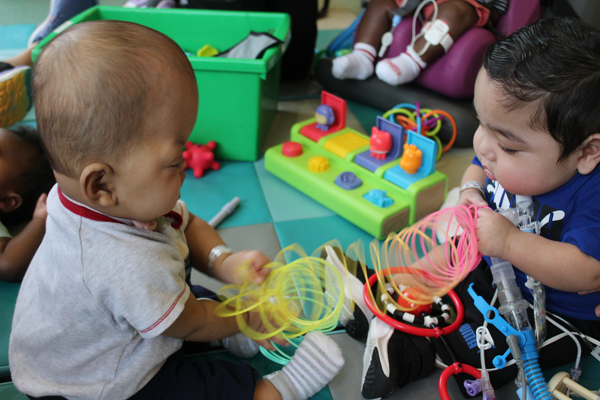 babies sharing toys